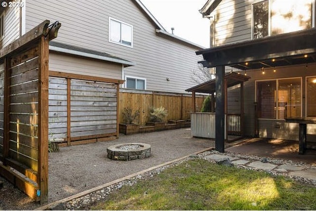 view of yard featuring a patio area and an outdoor fire pit