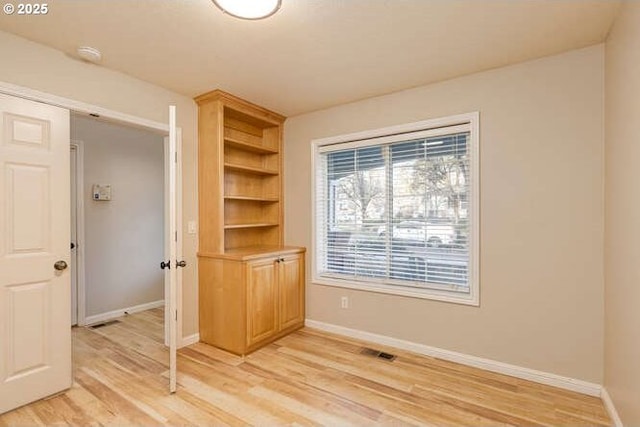 unfurnished room with light hardwood / wood-style floors