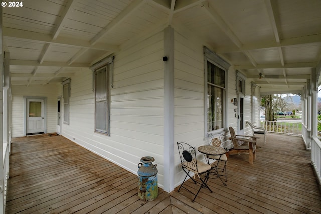 wooden terrace featuring covered porch