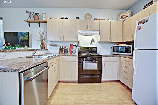 kitchen with light brown cabinetry, sink, light hardwood / wood-style floors, and stainless steel appliances