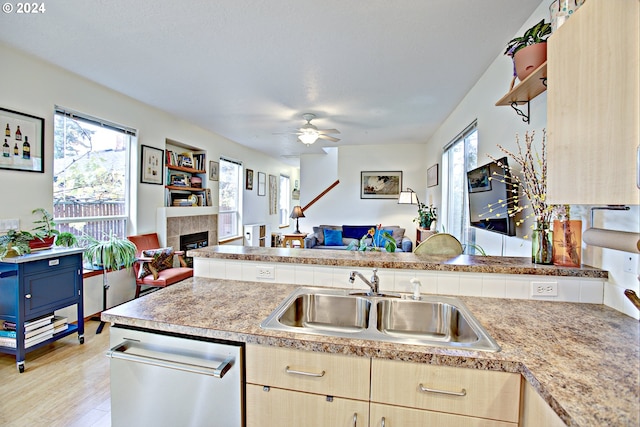 kitchen featuring light brown cabinets, a wealth of natural light, light hardwood / wood-style floors, and sink