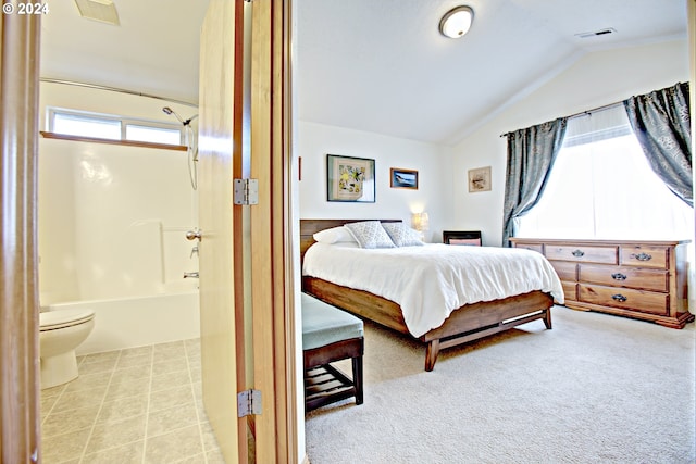 bedroom with light colored carpet and lofted ceiling