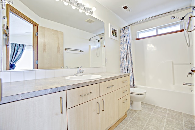 full bathroom featuring toilet, shower / tub combo with curtain, vanity, and tile patterned floors