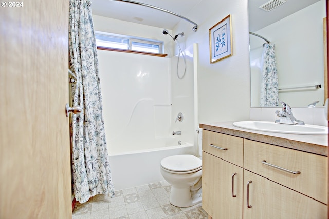 full bathroom featuring shower / bath combo, vanity, tile patterned floors, and toilet