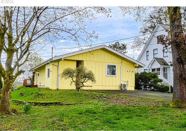 view of side of home with a yard