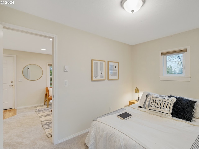 bedroom featuring light carpet