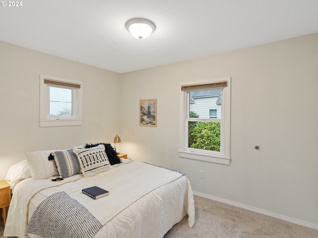 carpeted bedroom featuring multiple windows