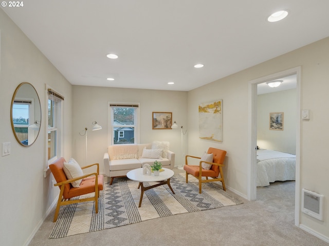 carpeted living room featuring heating unit