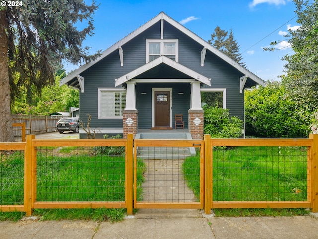 view of front of home featuring covered porch and a front lawn