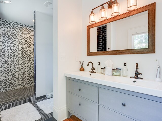 bathroom featuring vanity and a tile shower