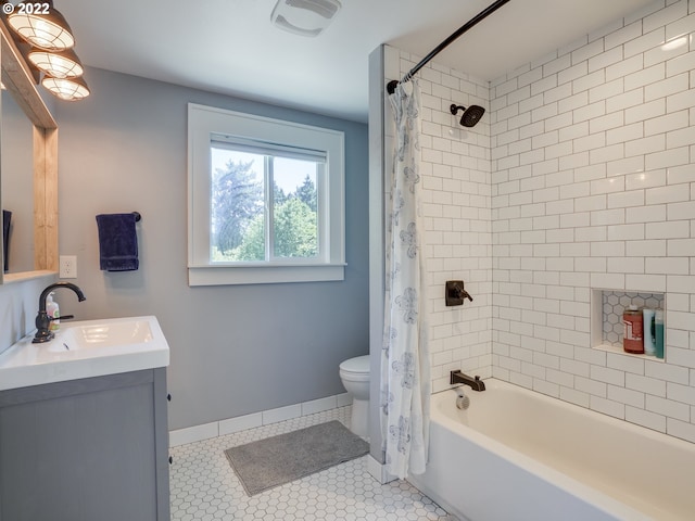 full bathroom featuring tile patterned floors, toilet, vanity, and shower / tub combo with curtain