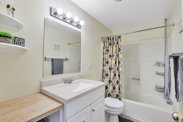 full bathroom with toilet, vanity, and shower / tub combo with curtain