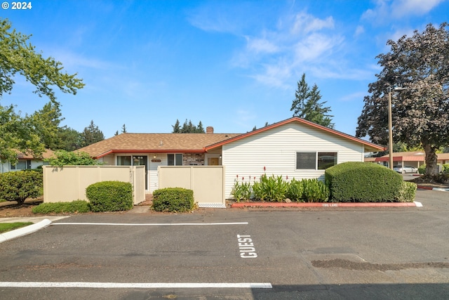 view of property featuring uncovered parking and a fenced front yard