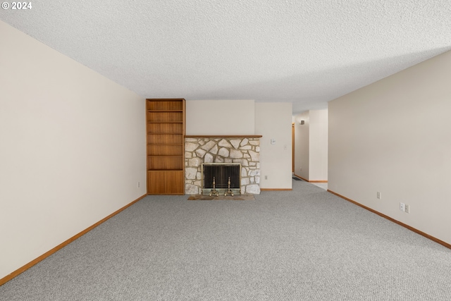 unfurnished living room featuring carpet flooring, a fireplace, and a textured ceiling