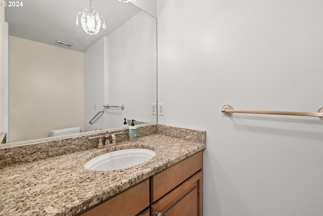 bathroom with toilet and vanity