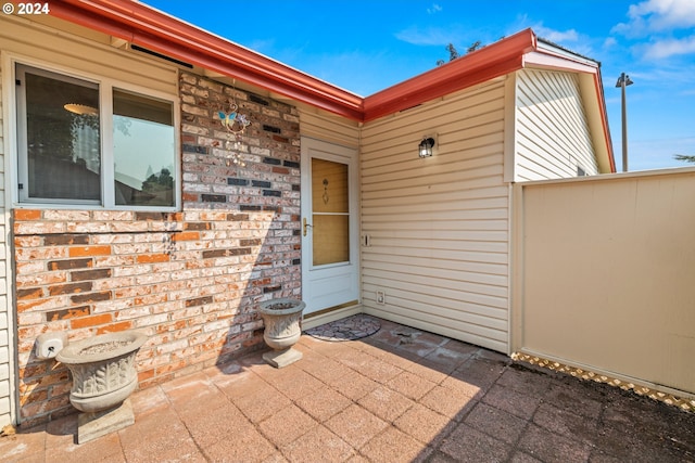 view of exterior entry featuring a patio area