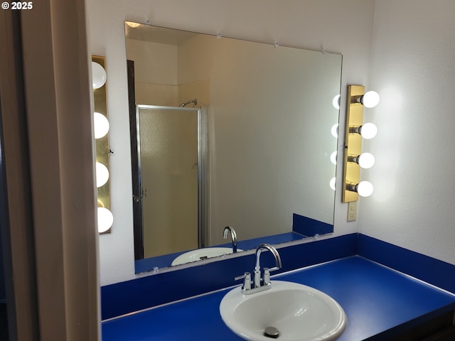 bathroom with an enclosed shower and sink