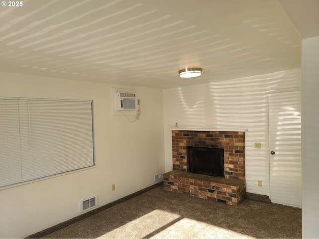 unfurnished living room with a brick fireplace, a wall mounted air conditioner, and dark colored carpet