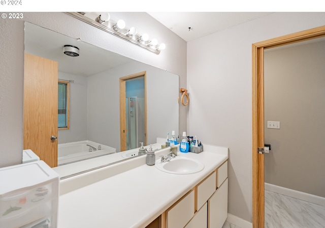 bathroom with vanity and a washtub