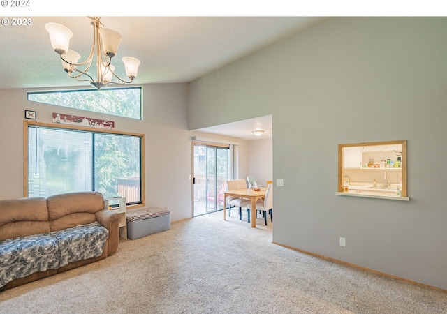 living room with carpet flooring, high vaulted ceiling, a notable chandelier, and sink