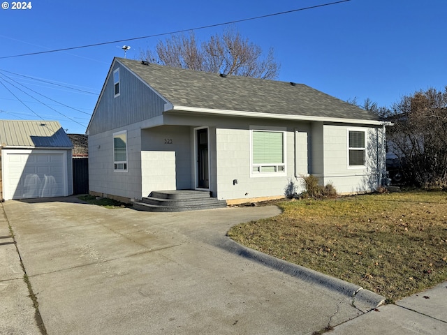 view of front of house with a garage and an outdoor structure