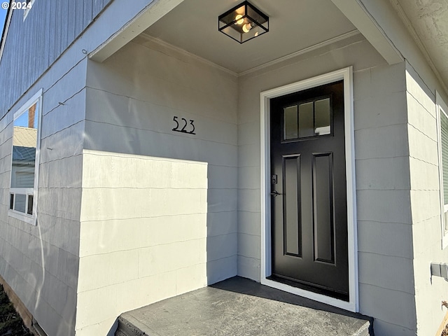 doorway to property featuring concrete block siding