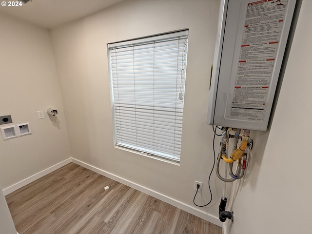 washroom with light wood-style flooring, hookup for an electric dryer, laundry area, washer hookup, and baseboards