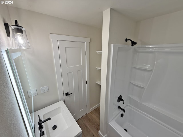 full bathroom with vanity, wood finished floors, and shower / tub combination