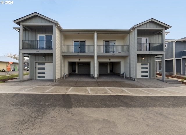 view of front of home with a garage and a balcony