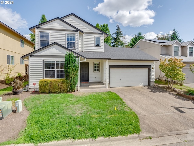 traditional-style home with driveway, a front yard, roof with shingles, and an attached garage