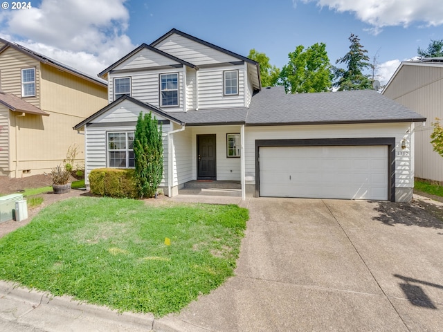 traditional-style home featuring a front yard, an attached garage, roof with shingles, and driveway