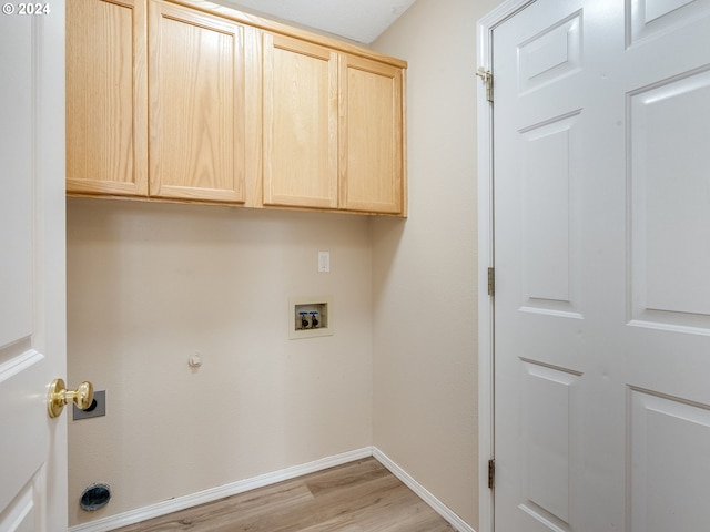 laundry room with light wood-type flooring, baseboards, cabinet space, and hookup for a washing machine