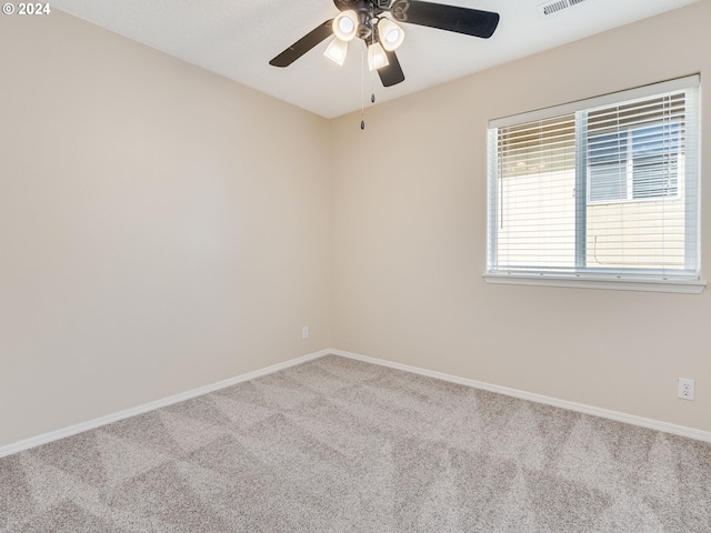 carpeted empty room featuring ceiling fan