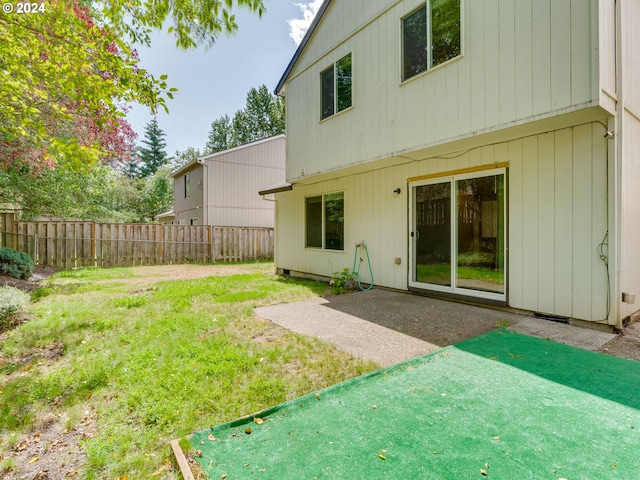 back of property featuring a yard and a patio