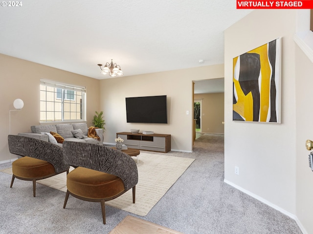 carpeted living room featuring a chandelier