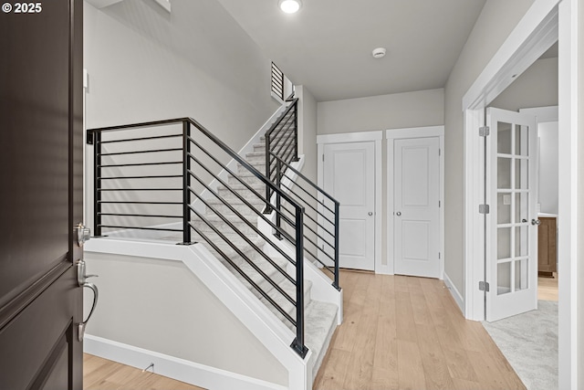 stairs featuring hardwood / wood-style floors