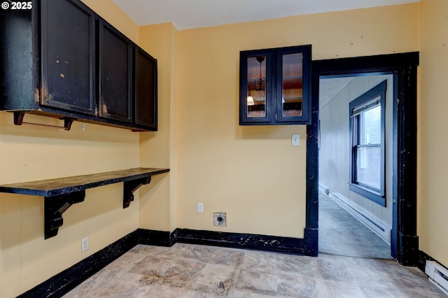 laundry area with a baseboard heating unit and hookup for an electric dryer