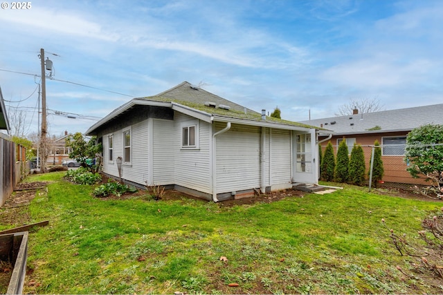 back of property featuring a lawn