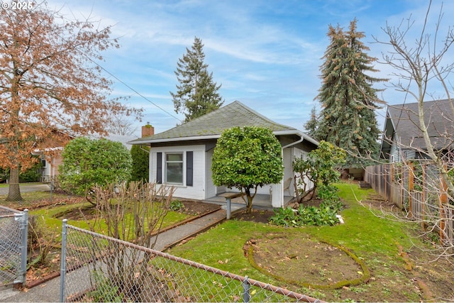 view of side of home with a lawn