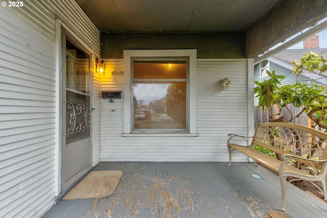 view of exterior entry with a patio