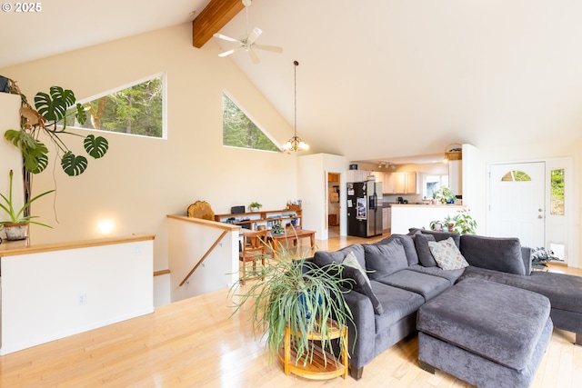 living room with beam ceiling, high vaulted ceiling, and light wood-style flooring