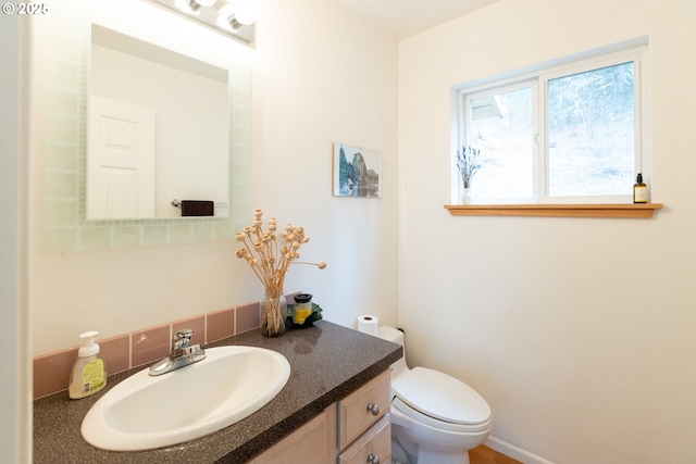 half bath with vanity and toilet