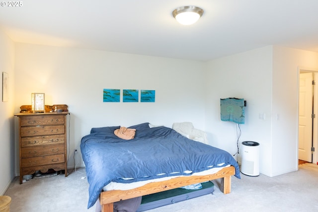 carpeted bedroom featuring baseboards