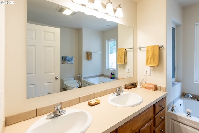 bathroom featuring a sink, a garden tub, and double vanity