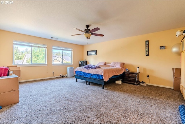 bedroom featuring a textured ceiling, ceiling fan, and carpet