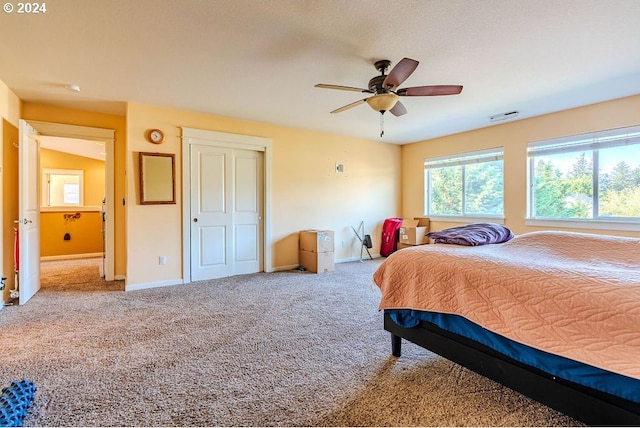 carpeted bedroom featuring ceiling fan and vaulted ceiling