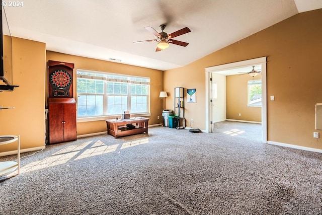 unfurnished room with ceiling fan, a wealth of natural light, carpet floors, and vaulted ceiling