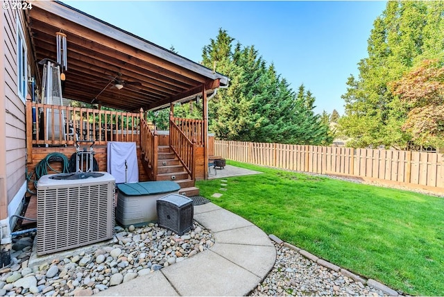 view of yard with central AC, ceiling fan, and a patio