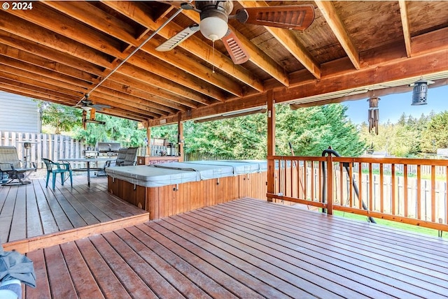 wooden deck featuring ceiling fan and a covered hot tub