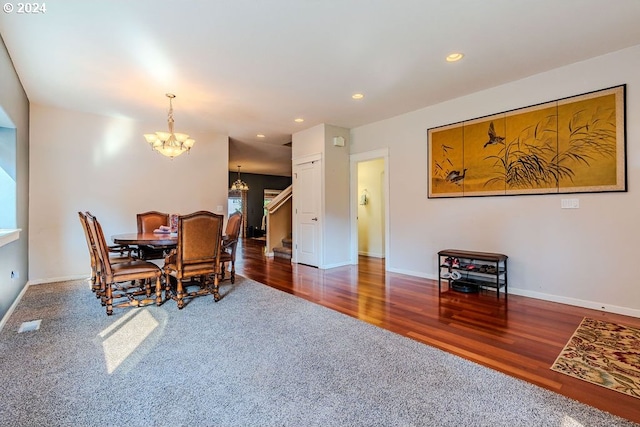 dining room featuring dark wood-type flooring and a chandelier